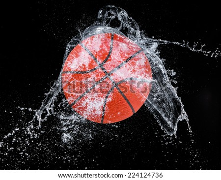 Water splash with sport ball on black background