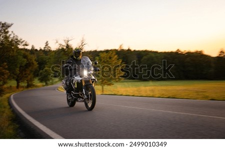 Similar – Foto Bild Motorradfahren bei Sonnenuntergang auf der leeren Straße bei einer Motorradtour. copyspace für Ihren individuellen Text.