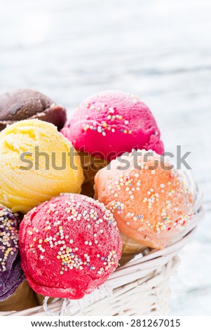 Ice cream scoops on wooden table, close-up.