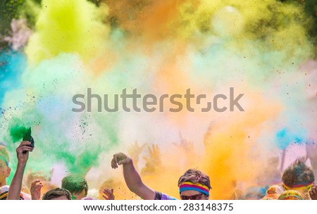 Close-up of marathon, people covered with colored powder.