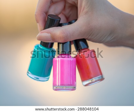woman hands with nail polishes, close-up.