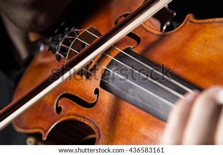 Similar – Foto Bild Nahaufnahme einer Violine mit Bogen. Braune Orchestergeige. Finger auf der Tastatur der Violine.