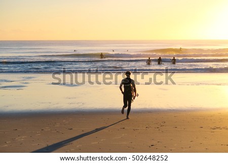 Similar – Image, Stock Photo Surfer at the beach carrying surfboard