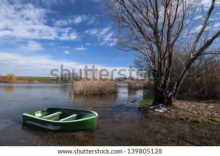 Green fishing boat in the lake