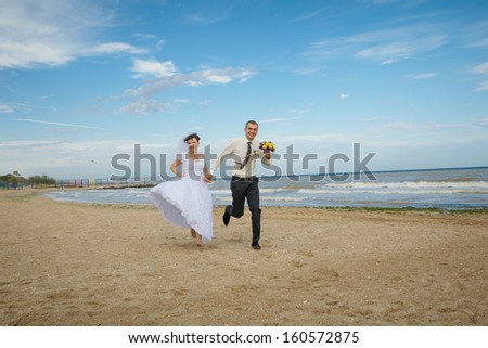 funny bride and groom blue background laughing and having fun