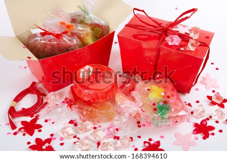 Many   handmade  soap in a red gift box on a white background