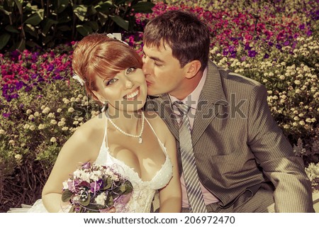 redhead  bride and happy  groom  gentle kiss on the cheek