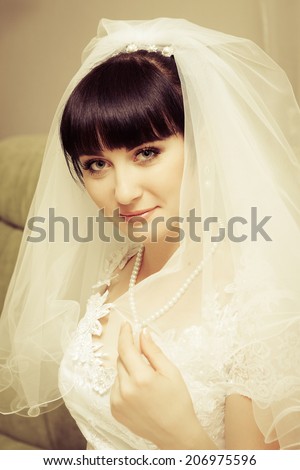 Portrait of a beautiful brunette bride with a bridal veil