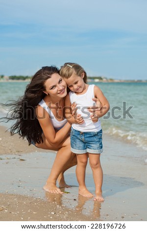 Happy family. Young happy beautiful  mother and her daughter having fun on the beach. Positive human emotions, feelings, emotions.