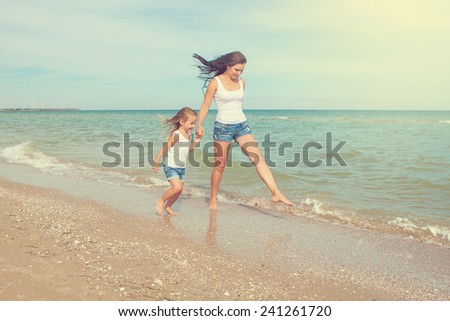 Happy family. Young happy beautiful  mother and her daughter having fun on the beach. Positive human emotions, feelings, emotions.