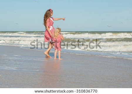 Happy family. Young happy beautiful  mother and her daughter  having fun on the beach. Positive human emotions, feelings, emotions.