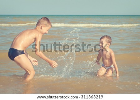 Happy family. Children - two boys having fun on the beach. Positive human emotions, feelings, emotions.
