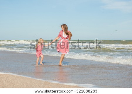 Happy family. Young happy beautiful  mother and her daughter  having fun on the beach. Positive human emotions, feelings, emotions.
