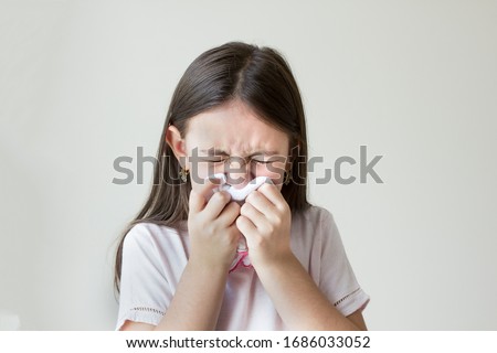 Flu concept - Upset and sick child blowing his nose with flu symptoms coughing at home, Allergic girl, flu season. Girl with cold rhinitis, cold Zdjęcia stock © 