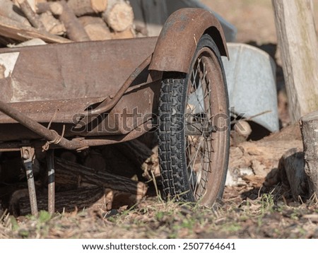 Similar – Image, Stock Photo An old rusty wheelbarrow with a fat black balloon tyre tries to hide in a lilac bush, but doesn’t quite succeed