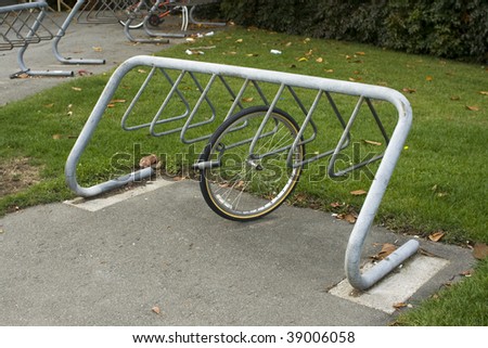 A bike rack with a wheel locked to it