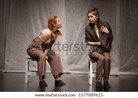 The duet of the actress girl plays a modern lyrical performance of the show on the stage of the theater