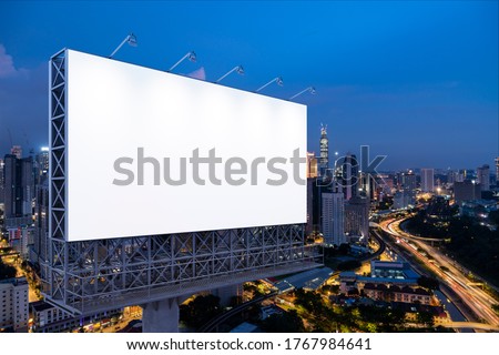 Blank white road billboard with KL cityscape background at night time. Street advertising poster, mock up, 3D rendering. Side view. The concept of marketing communication to promote or sell idea. Stock foto © 