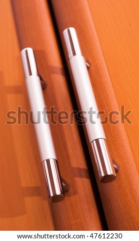white metal handles on cabinet doors