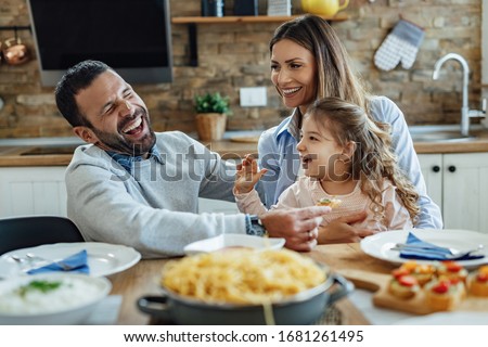 Similar – Image, Stock Photo Woman having lunch and browsing smartphone at home