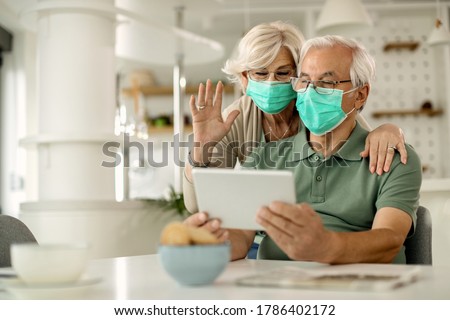 Similar – Image, Stock Photo Senior couple wearing protective face masks outdoors