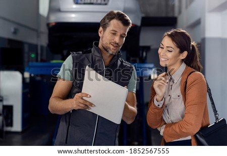 Similar – Image, Stock Photo Mechanic reading document in workshop