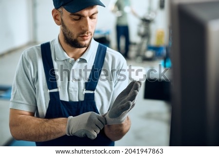 Similar – Image, Stock Photo Mechanic putting on protective mask in workshop