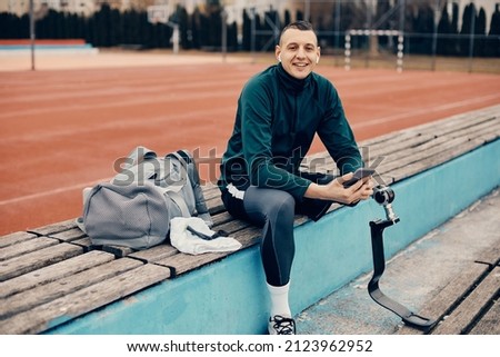 Similar – Image, Stock Photo Disabled athlete using phone