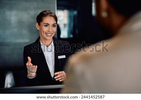 Similar – Image, Stock Photo Female traveler talking on her cell phone while waiting to board a plane at departure gates at airport terminal.