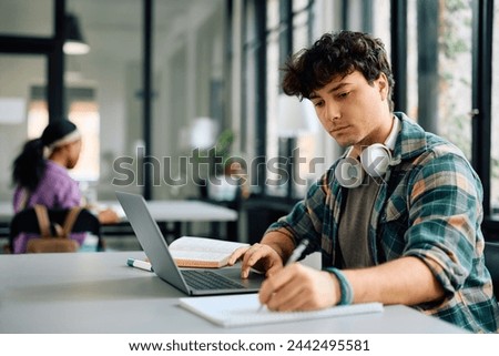 Image, Stock Photo Student learning in university library. Young woman having video class listening to online course using laptop. Focused student studying for college exams. Using technology