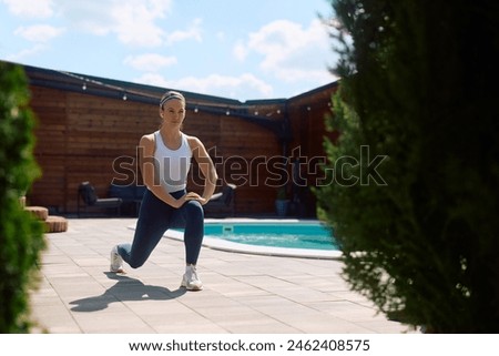 Similar – Image, Stock Photo Flexible young sportswoman practicing yoga on street