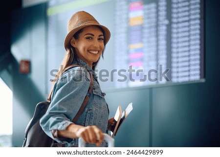 Similar – Foto Bild Frau am Flughafen, die auf die Fluginformationstafel schaut.