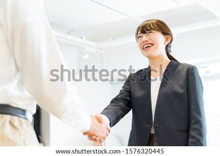 Women in suits shaking hands with men ストックフォト © 