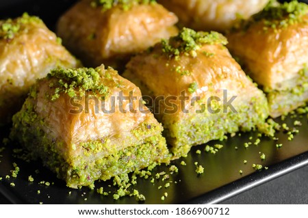 Traditional turkish dessert antep baklava with pistachio on rustic table,  ramadan or holiday desserts concept