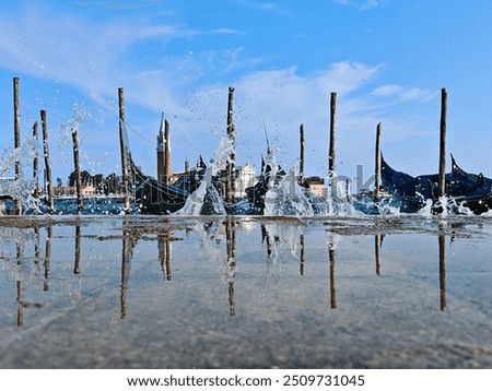 Similar – Image, Stock Photo The gondolas splash in the blue calm water. They are attached to wooden poles.