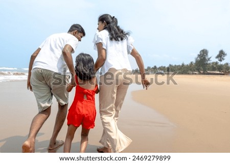 Similar – Foto Bild Zeit in Familienqualität. Vater und Tochter sitzen in einem selbstgebauten rosa Zelt mit Blumen, lesen ein großes Buch, sehen sich an, lächeln und lachen. Gemütliches stilvolles Zimmer. Konzept für Familienbande