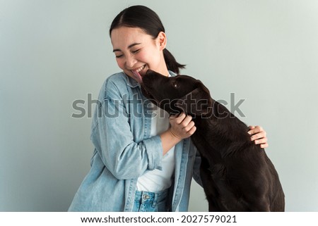 Similar – Image, Stock Photo Caucasian woman holding puppy. Adopted border collie dog held by a caucasian woman with long blond hair. Friendship and family.