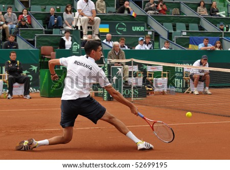 BUCHAREST, ROMANIA - MAY 9: Romanian Victor Hanescu is stretching after a ball during the fourth match of the Davis Cup meeting between Romania and Ukraine at the BNR Arenas on May 9, 2010 in Bucharest, Romania.