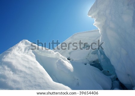 Snow covered cave and sky background against the sunlight in spray lake, kananaskis, alberta