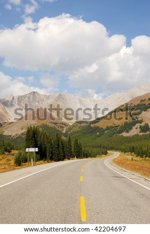 Autumn scenic view of rocky mountains, forests and road (highway 40) while traveling in kananaskis country, alberta, canada
