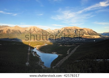 Bird view of the bow valley and mountains in lights and shadows in the sunset moment, banff national park, alberta, canada