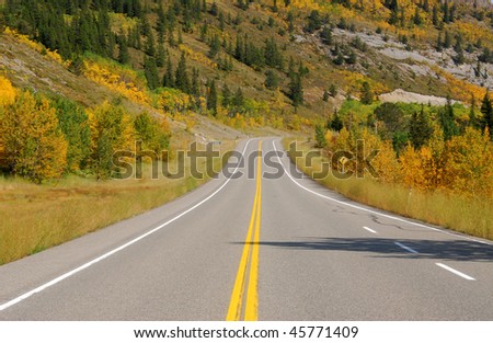 Autumn scenic view of rocky mountains, forests and road (highway 40) while traveling in kananaskis country, alberta, canada