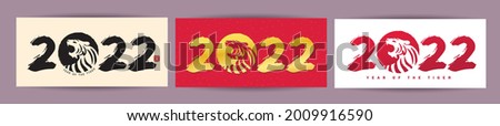2022 year of the Tiger calligraphic or symbol in black, gold and red color. 2022 and tiger with brush stroke effect. Happy chinese new year. Flat vector design.