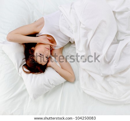 young beautiful woman lying on the bed.