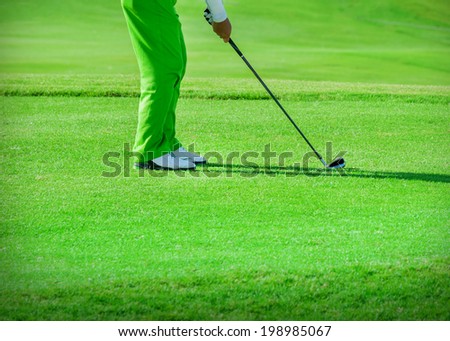 Golf club. Man playing golf Green golf field and ball in grass