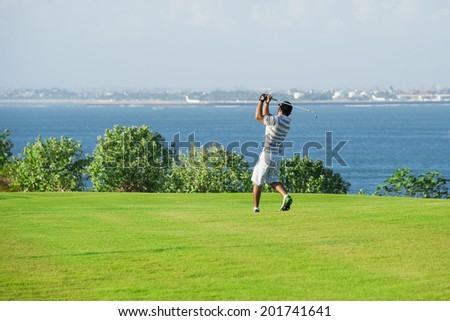 Golf club. Man playing golf Green golf field and ball in grass