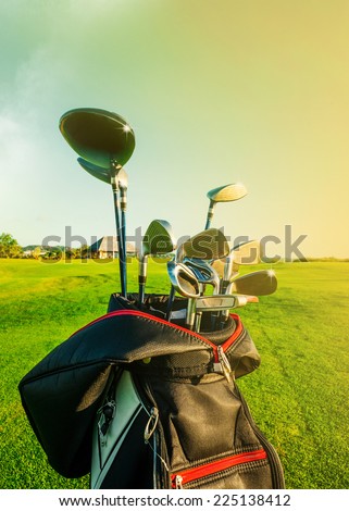 Golf club. Bag with golf clubs Green golf field and ball in grass