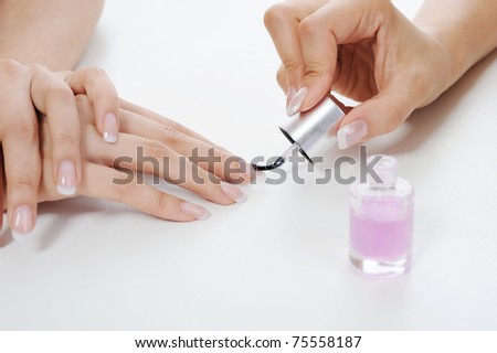 girl does a manicure in the salon