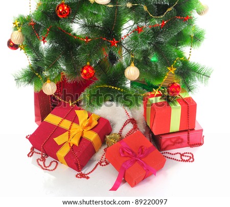 Christmas tree with heap of red gift boxes decorated. isolated on white background