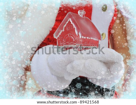 ice house in the hands, Santa Claus Christmas presents.